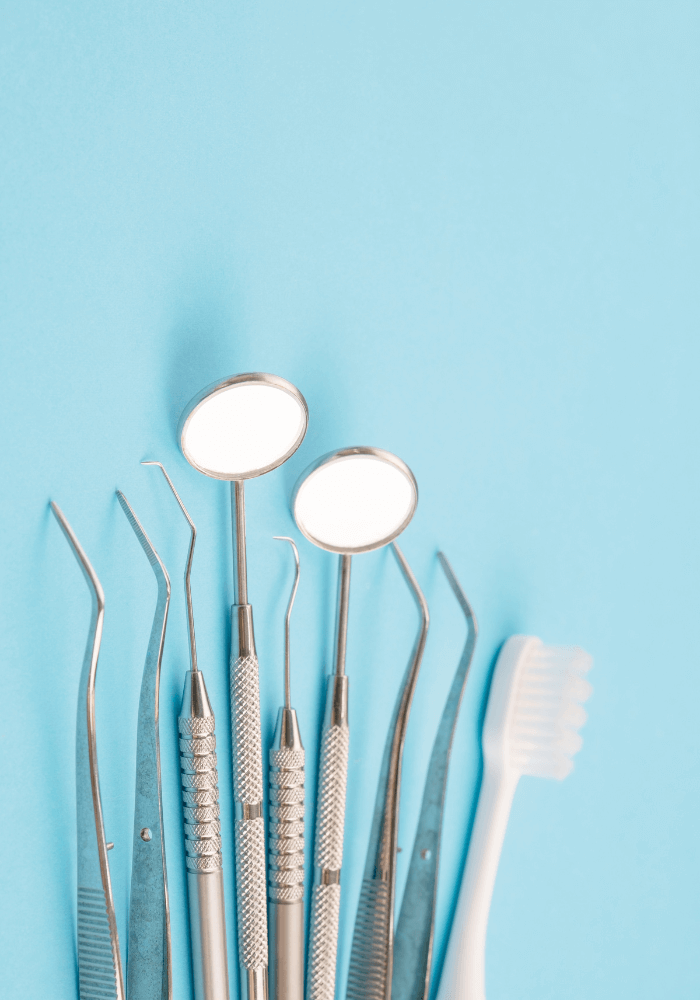 Image of dental tools on a blue background, representing dental instruments.